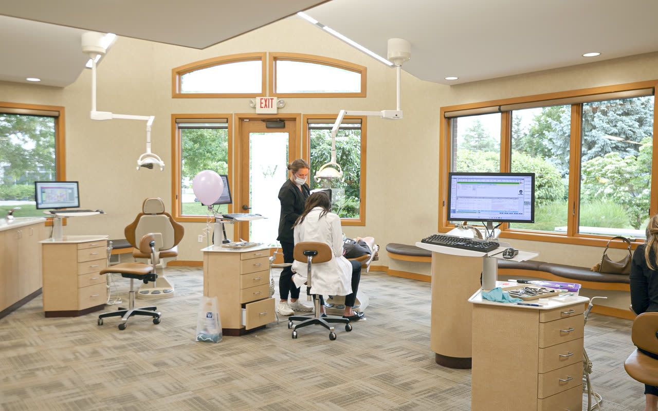 Orthodontic team fitting Invisalign® aligners for a patient in Grand Rapids, MI