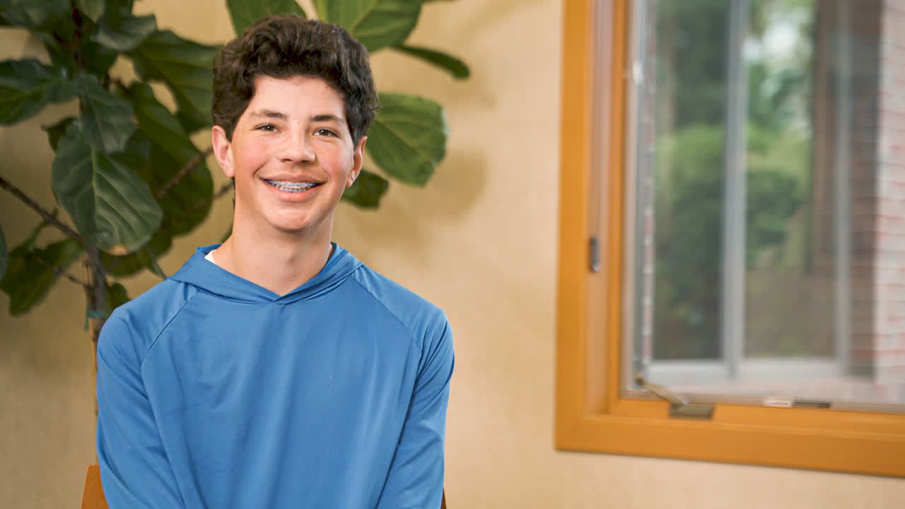 Smiling teen patient with braces from the Jackson family at Armbrecht & Wierenga Orthodontics in Grand Rapids, MI