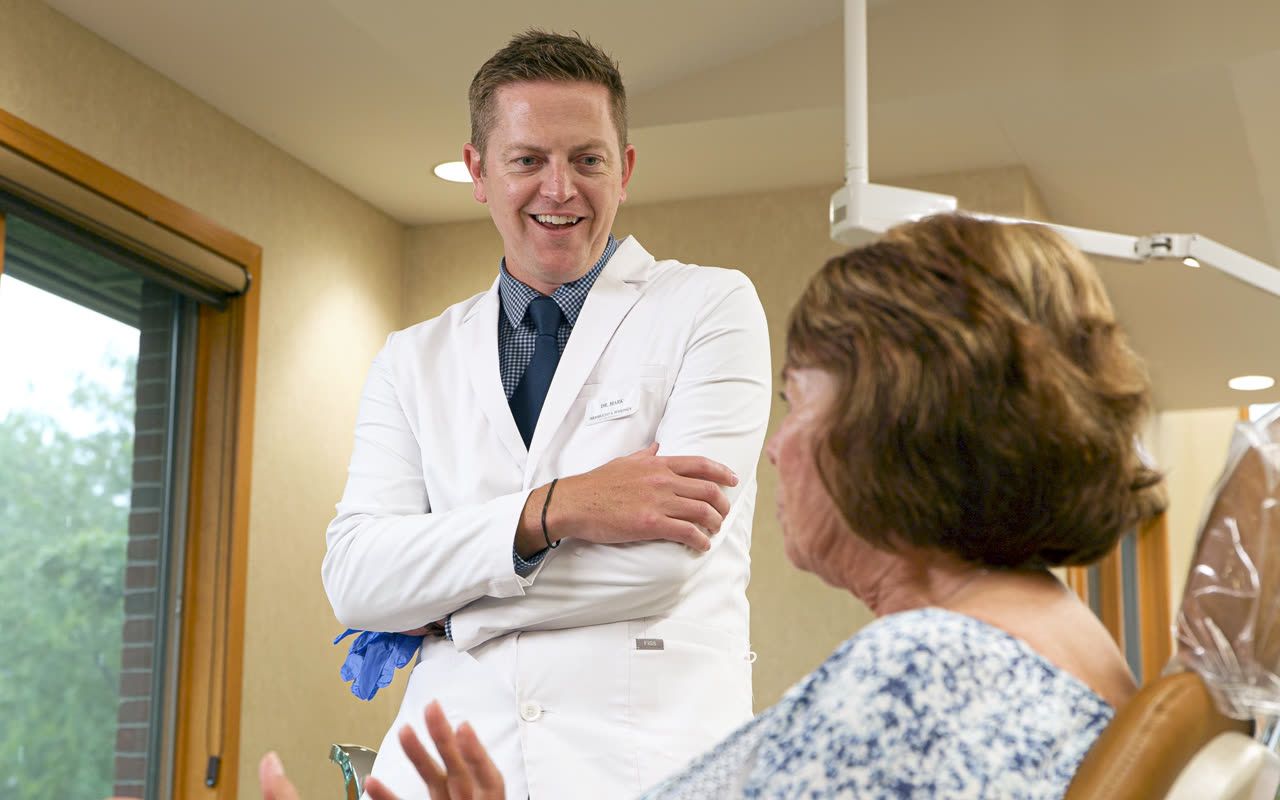 Orthodontist discussing Invisalign® clear aligners with a patient in Grandville, MI