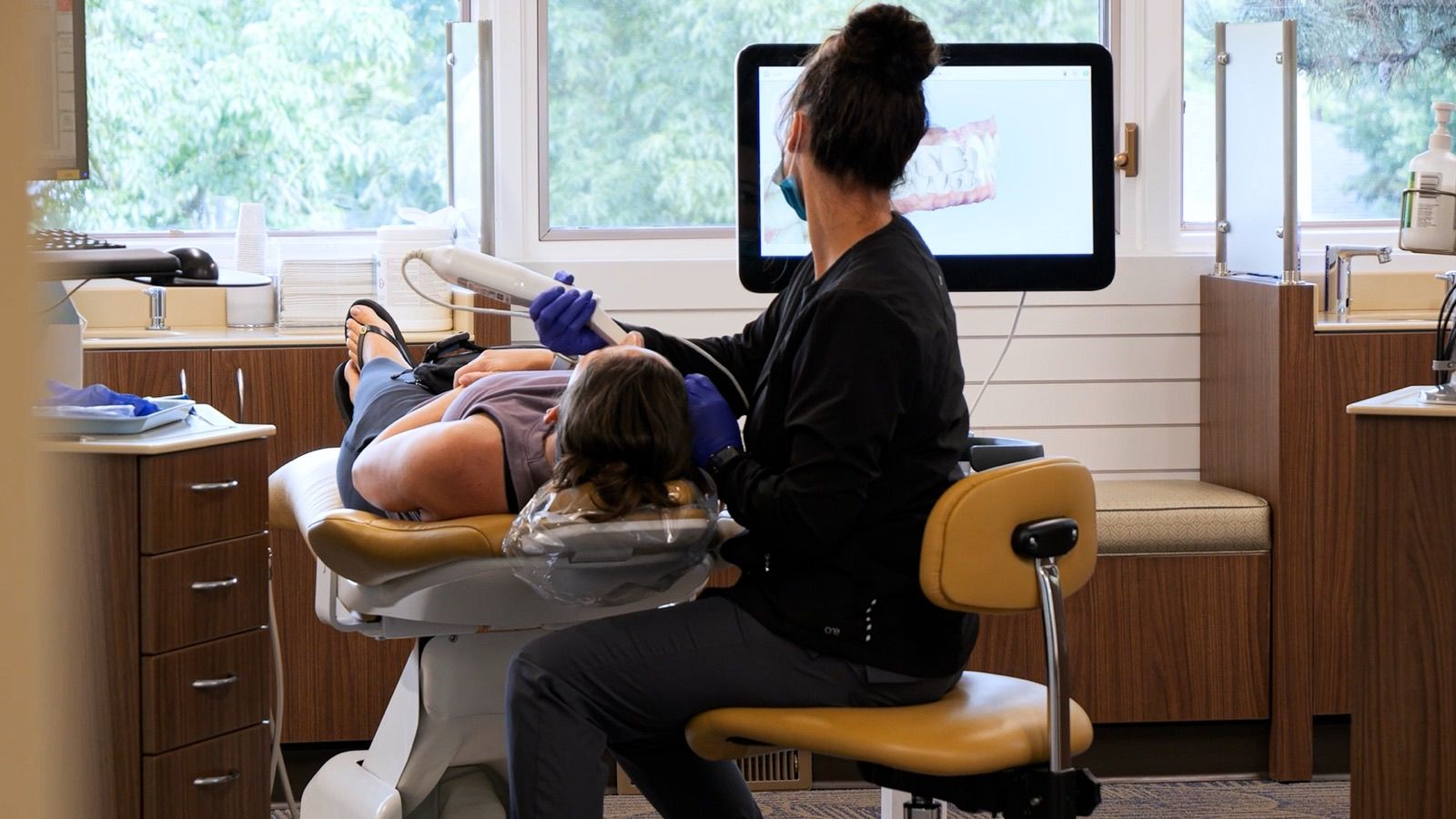 iTero® scanner wand capturing a live 3D digital scan of a patient's teeth in Grandville, MI